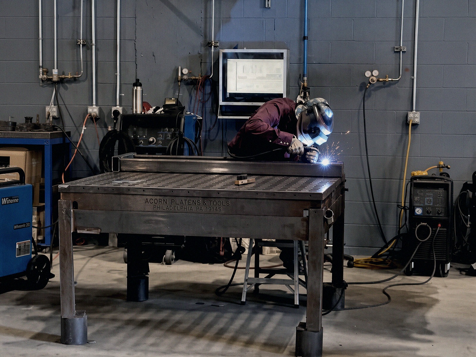 Welder building a large steel frame in our welding bay